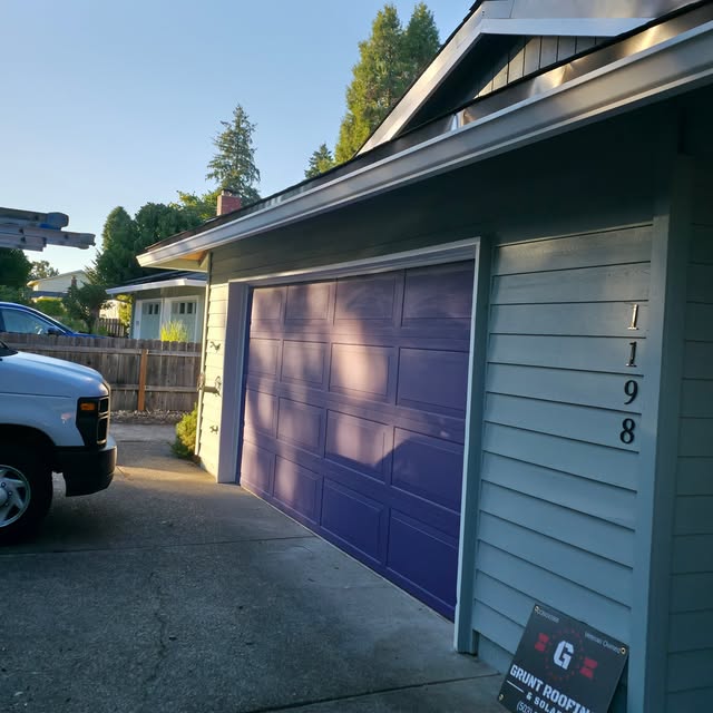 Freshly painted garage door in custom purple on residential home